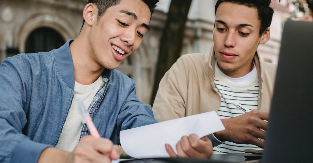Do I need to include documents about my friend when he is not my sponsor? - Smiling ethnic male learner writing in document while doing homework assignment with classmate in park Do I need to include documents about my friend when he is not my sponsor? - Smiling ethnic male learner writing in document while doing homework assignment with classmate in park