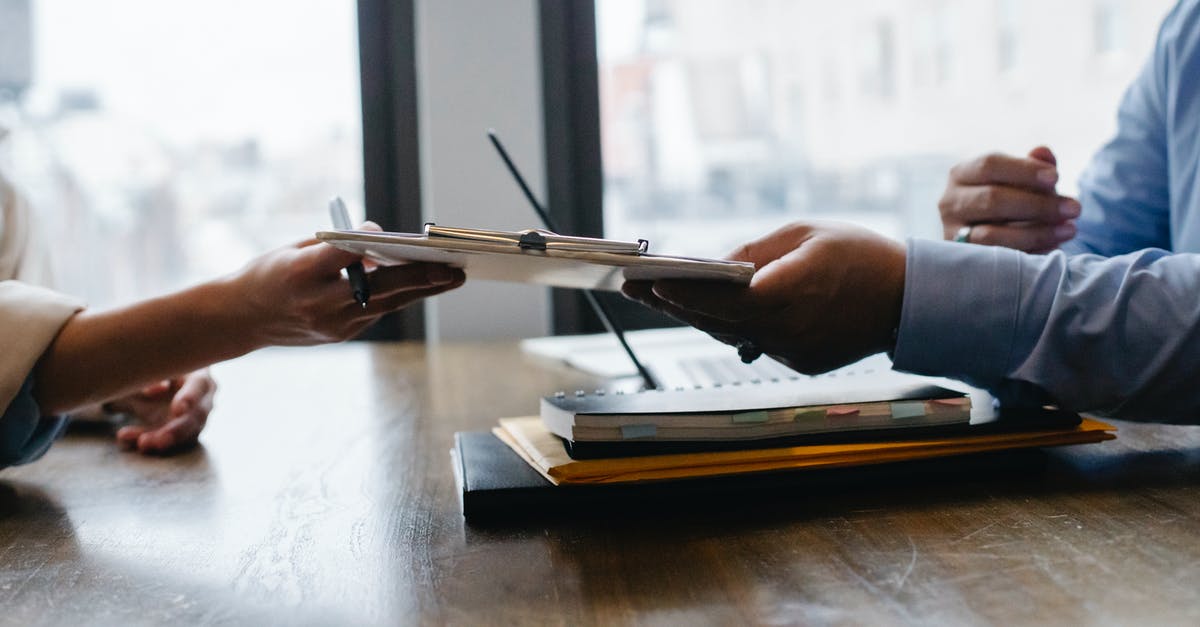 Do I need to pass through emmigration? - Crop anonymous ethnic woman passing clipboard to office worker with laptop during job interview Do I need to pass through emmigration? - Crop anonymous ethnic woman passing clipboard to office worker with laptop during job interview