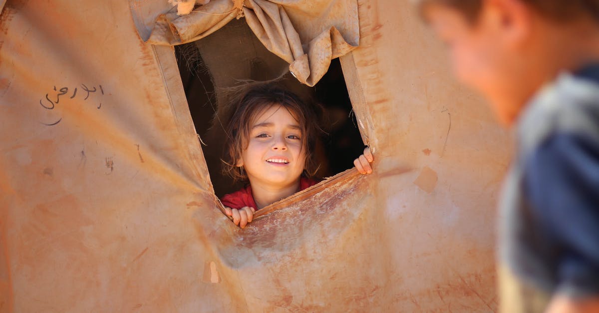 Do I need to physically crop my passport photo? - Smiling little ethnic girl looking out of window in tent Do I need to physically crop my passport photo? - Smiling little ethnic girl looking out of window in tent