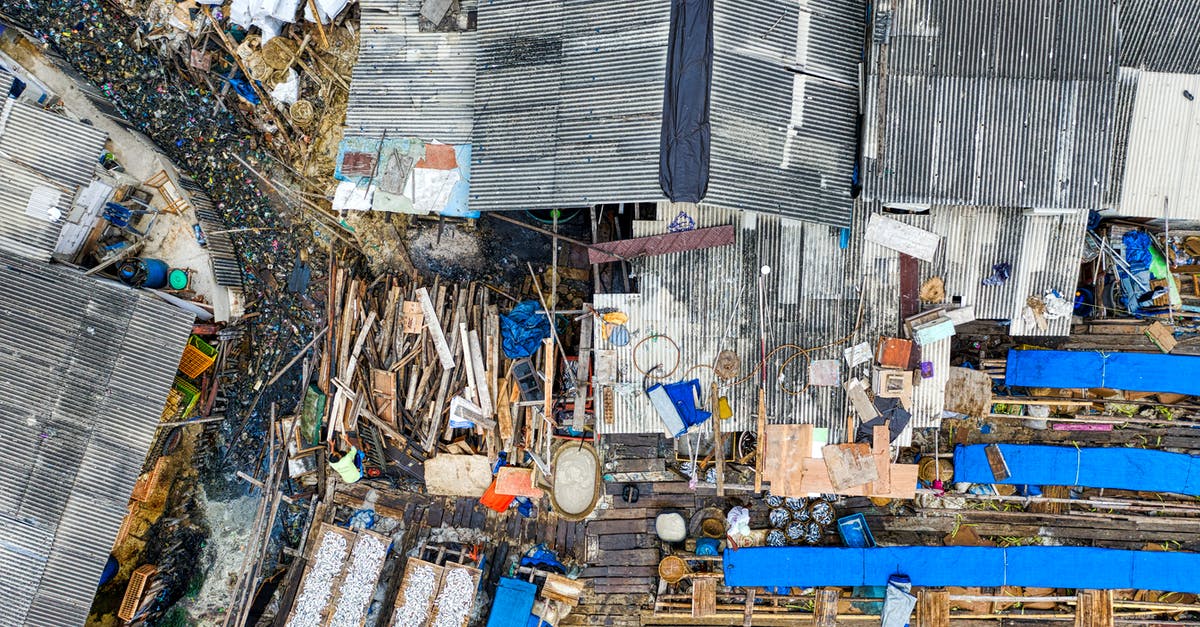 Do I need to use the same passport when entering Japan? - Grungy buildings near dump in ghetto Do I need to use the same passport when entering Japan? - Grungy buildings near dump in ghetto
