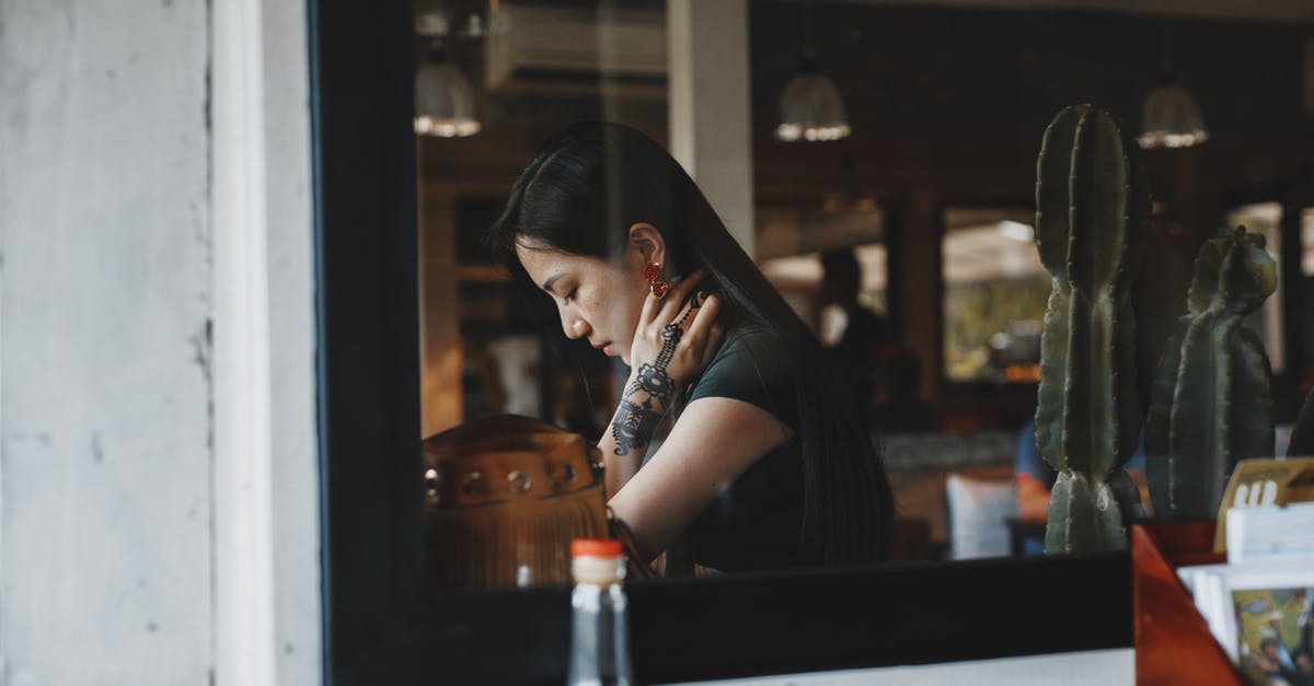 Do Mexican nationals have to go through immigration and customs in Mexico? - Young woman with arm tattoo reading in quiet cafe Do Mexican nationals have to go through immigration and customs in Mexico? - Young woman with arm tattoo reading in quiet cafe