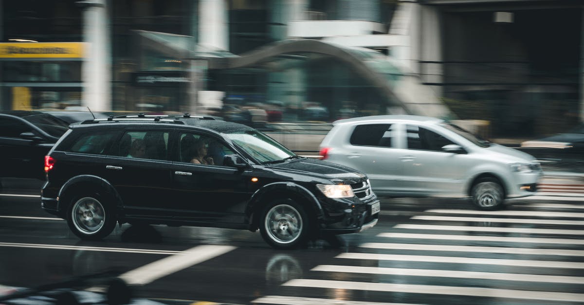 Do roll-on/roll-off (RORO) ships take passengers and their car? - Black Suv Beside Grey Auv Crossing the Pedestrian Line during Daytime Do roll-on/roll-off (RORO) ships take passengers and their car? - Black Suv Beside Grey Auv Crossing the Pedestrian Line during Daytime