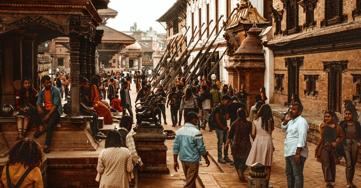 Do stores at tourist-heavy sites in Nepal accept USD? - People Standing Near Building Do stores at tourist-heavy sites in Nepal accept USD? - People Standing Near Building