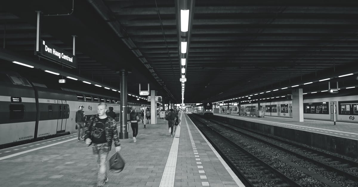 Do trains run to Beni Nsar Port in Morocco? - Grayscale Photography of Man Carrying Bag Walking on Subway Station Do trains run to Beni Nsar Port in Morocco? - Grayscale Photography of Man Carrying Bag Walking on Subway Station