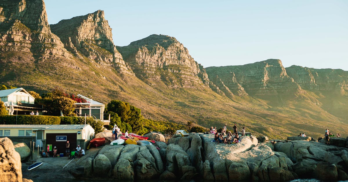 Do transits count as days towards an overstay in South Africa? - People Sitting on Gray Rock Near Green Mountain Do transits count as days towards an overstay in South Africa? - People Sitting on Gray Rock Near Green Mountain