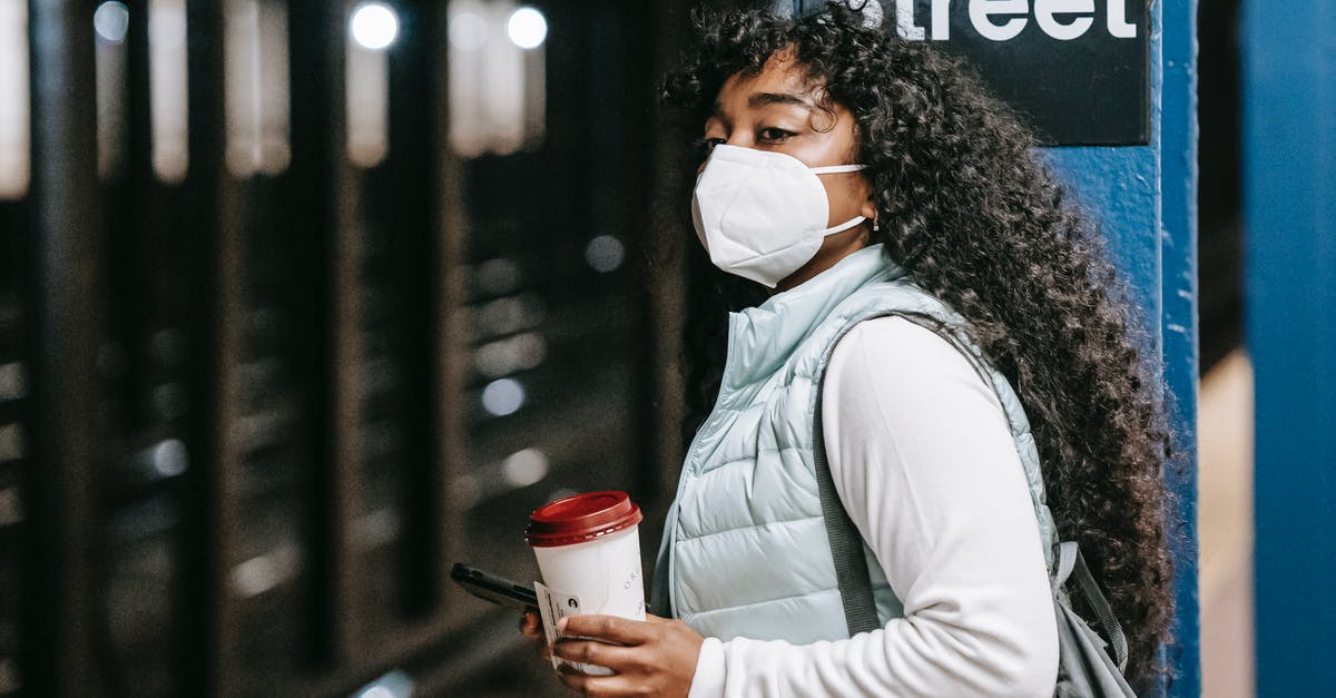Do U.S. citizens need a Russian transit visa? - Black woman in respirator waiting for train in subway Do U.S. citizens need a Russian transit visa? - Black woman in respirator waiting for train in subway