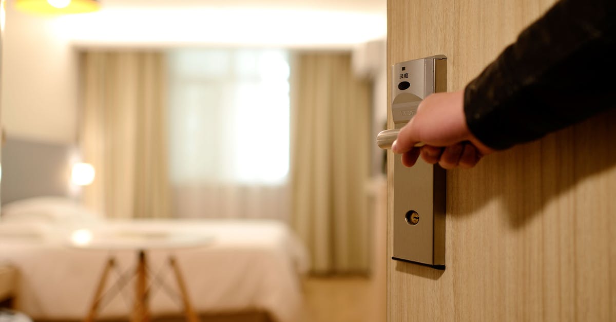 Do we need to take our marriage certificate to show to a hotel in New Delhi? - Person Holding on Door Lever Inside Room Do we need to take our marriage certificate to show to a hotel in New Delhi? - Person Holding on Door Lever Inside Room