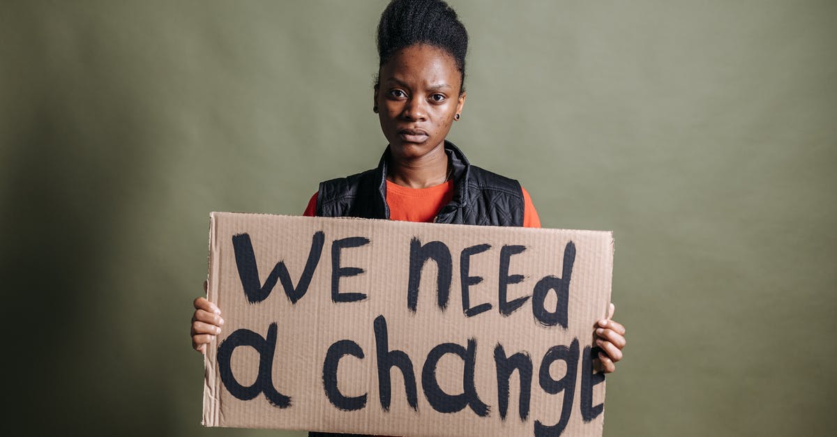 Do we need transit visas for Iceland if we have a two-hour layover? [duplicate] - A Woman Holding a Placard