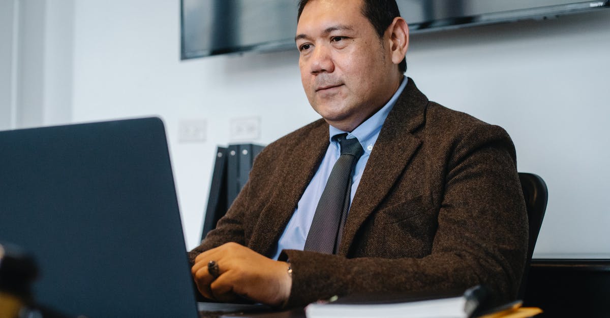 Document stamping - Focused ethnic businessman using netbook while working in office