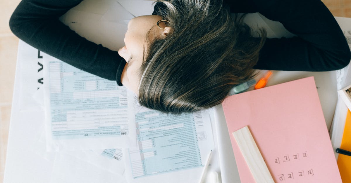 Documents for Standard Visitor Visa UK - Woman in Blue Long Sleeve Shirt Lying on White Printer Paper Documents for Standard Visitor Visa UK - Woman in Blue Long Sleeve Shirt Lying on White Printer Paper