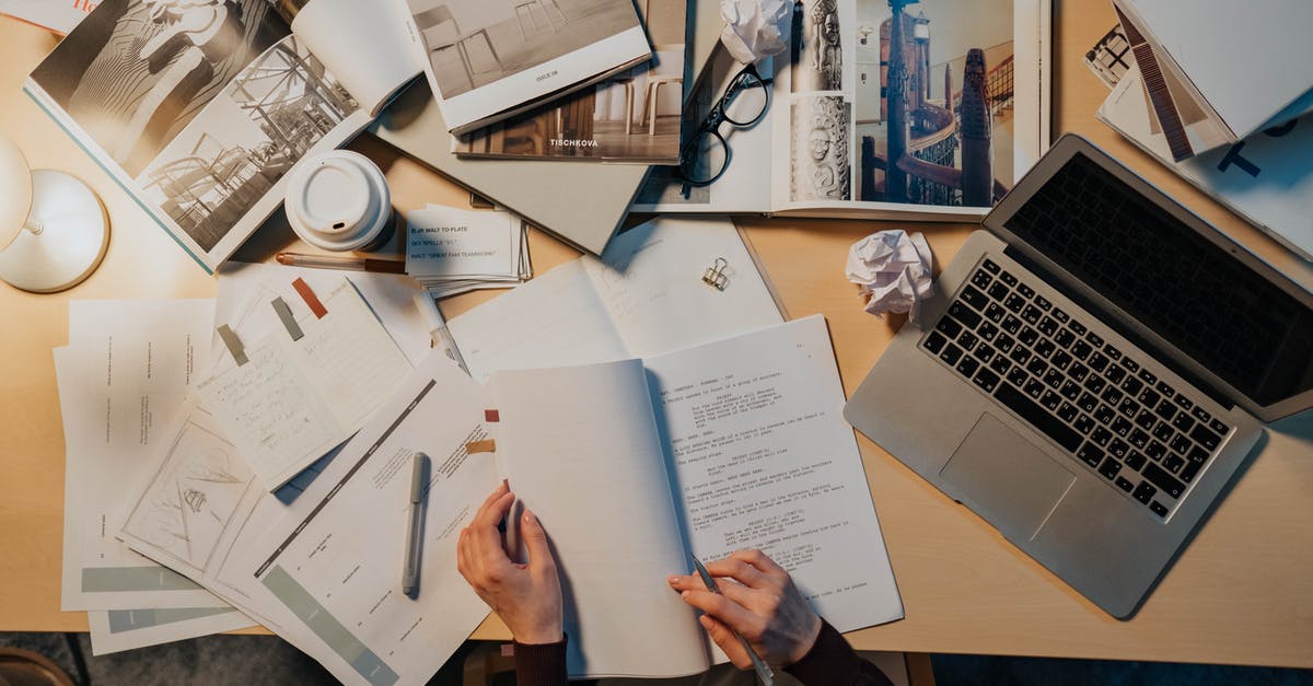 Documents required to go to Alaska from Vancouver - Person Reading a Script on a White Paper