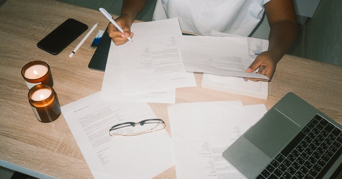 Documents required to go to Alaska from Vancouver - A Person Working on Documents