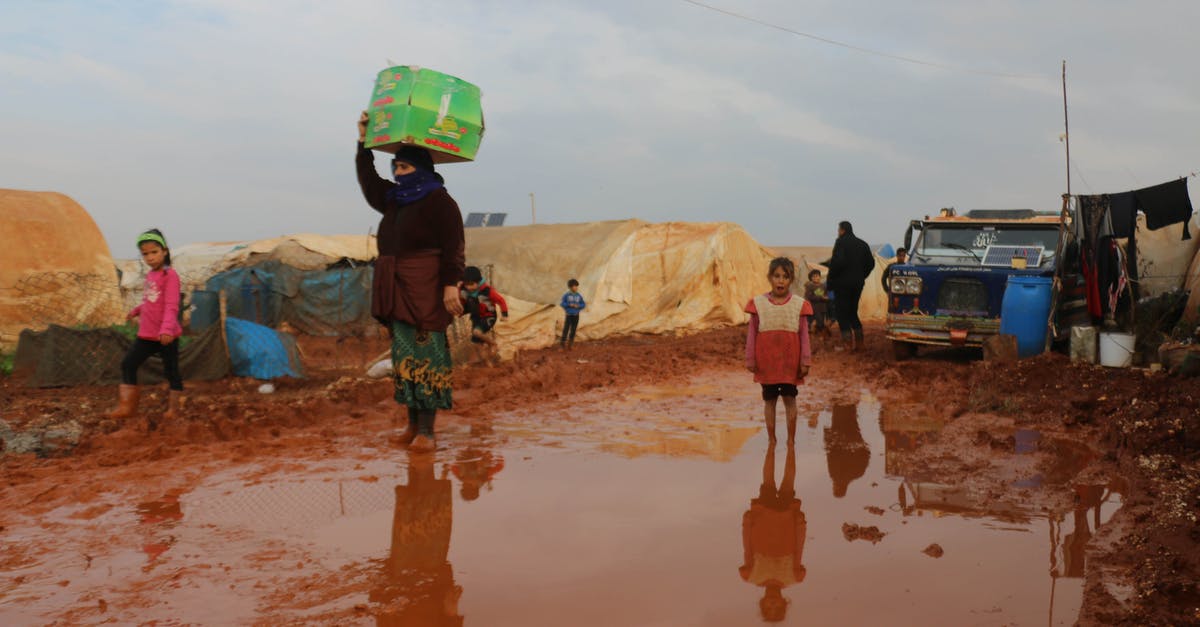 Does a 7 years old child need a separate bank statement? - Ethnic children and adults refugees walking on dirty ground Does a 7 years old child need a separate bank statement? - Ethnic children and adults refugees walking on dirty ground