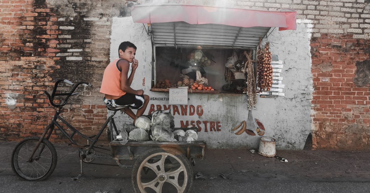Does a 7 years old child need a separate bank statement? - Ethnic boy sitting on aged tricycle near poor street stall Does a 7 years old child need a separate bank statement? - Ethnic boy sitting on aged tricycle near poor street stall