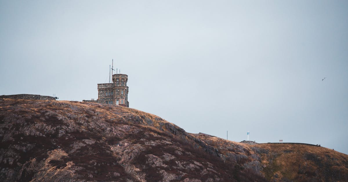 Does a Canadian permanent resident need a transit visa in Canada? - Old tower facade on hill under light sky Does a Canadian permanent resident need a transit visa in Canada? - Old tower facade on hill under light sky