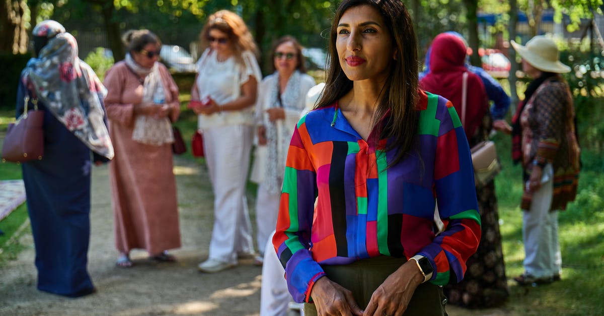Does a group travelling to the UK apply for their visas together or individually? - Positive adult woman standing in park