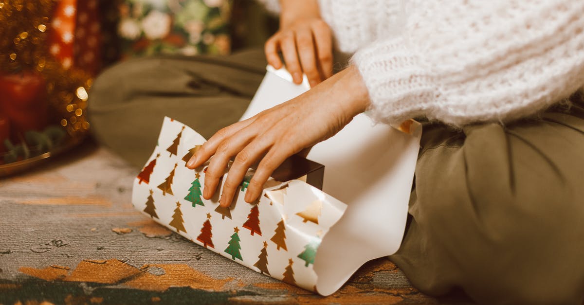 Does a minor need to be present to apply for a passport in Colombia? [closed] - Woman Sitting on the Floor and Wrapping a Present
