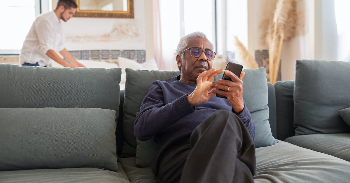 Does a seat cushion help for 12+ hour flights? - Man in Black Long Sleeve Shirt Sitting on Gray Couch Does a seat cushion help for 12+ hour flights? - Man in Black Long Sleeve Shirt Sitting on Gray Couch