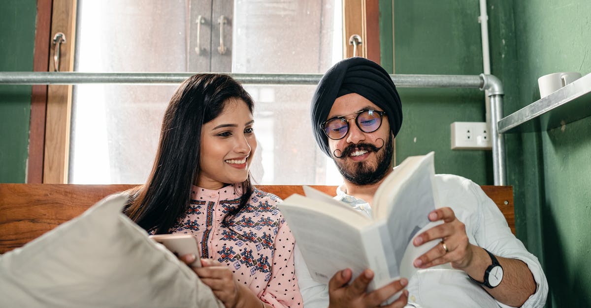 Does an Indian with a UK Tier 2 visa need to book flights before applying for a Schengen visa? [ [duplicate] - Smiling couple with book on bed