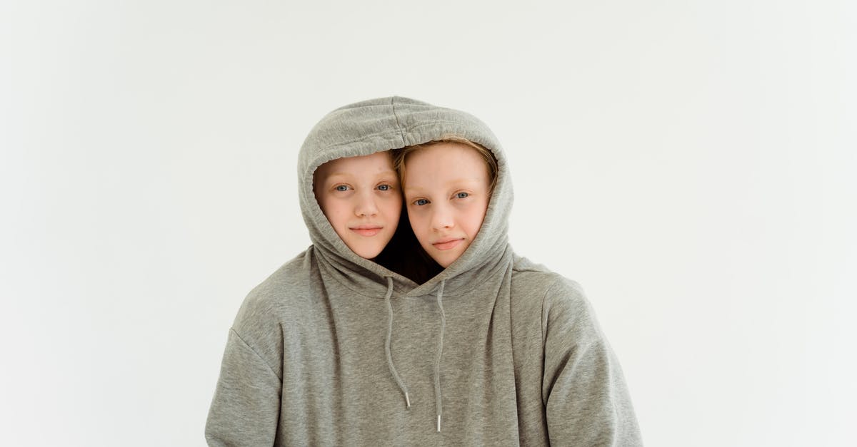 Does anything stop identical twins from traveling on each other's passports? - Two Young Girls Together in One Gray Hoodie Sweater Does anything stop identical twins from traveling on each other's passports? - Two Young Girls Together in One Gray Hoodie Sweater