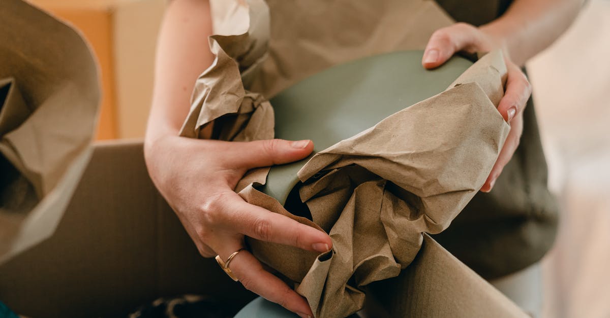 Does declaring your baggage as fragile do anything good? - Crop woman with packing paper and belongings Does declaring your baggage as fragile do anything good? - Crop woman with packing paper and belongings