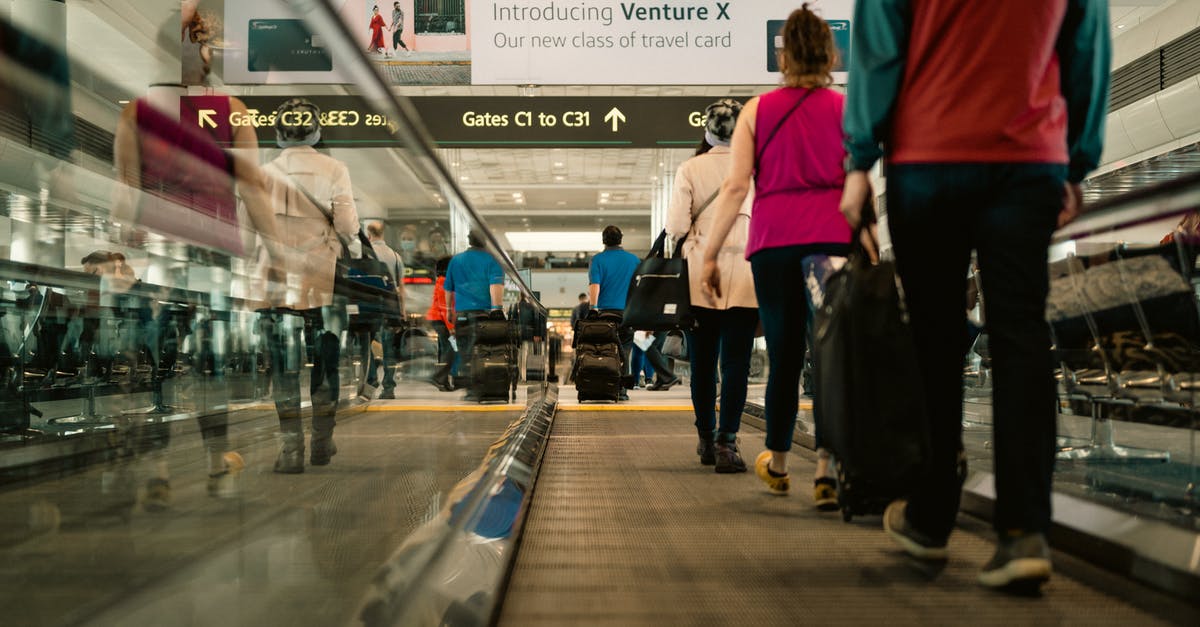 Does DFW have moving walkways in any terminal? - People Using a Moving Walkway in an Airport Does DFW have moving walkways in any terminal? - People Using a Moving Walkway in an Airport
