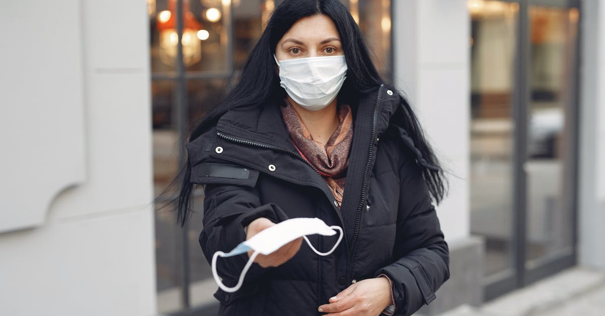 Does Eurail Continuous Global pass offer unlimited trips? - Young woman wearing medical mask and black down jacket on urban street in cold season Does Eurail Continuous Global pass offer unlimited trips? - Young woman wearing medical mask and black down jacket on urban street in cold season