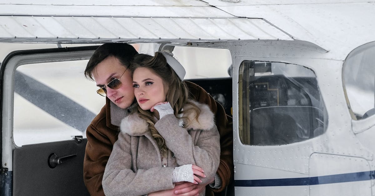 Does giving blood affect plane travel? - Stylish young couple in warm coats hugging gently near modern private jet and looking away on cold winter day Does giving blood affect plane travel? - Stylish young couple in warm coats hugging gently near modern private jet and looking away on cold winter day