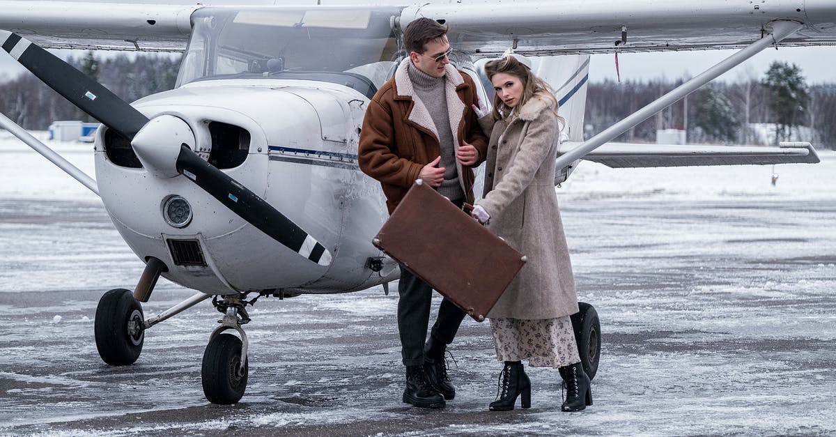 Does giving blood affect plane travel? - Stylish couple standing close near propeller jet on airfield Does giving blood affect plane travel? - Stylish couple standing close near propeller jet on airfield