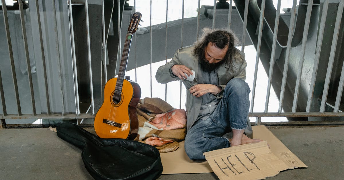 Does having a B1/B2 help your case for a Schengen visa? - A Homeless Man Sitting on a Cardboard Does having a B1/B2 help your case for a Schengen visa? - A Homeless Man Sitting on a Cardboard