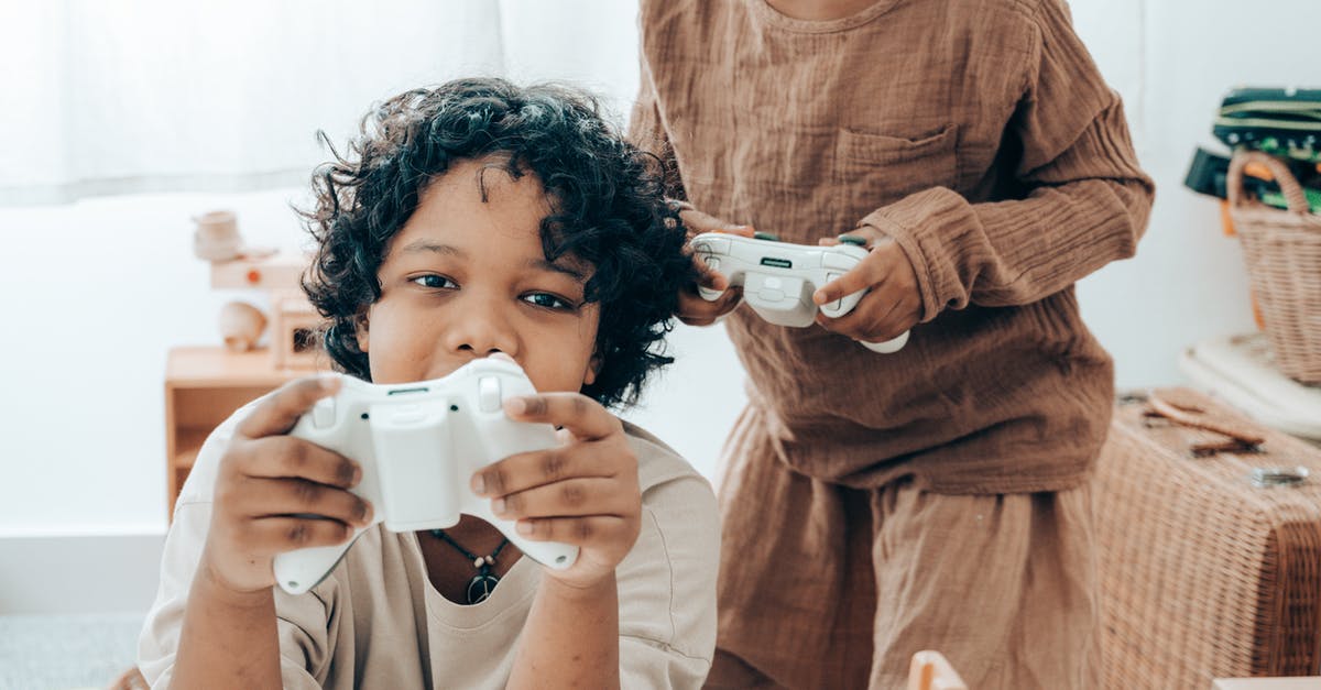 Does Icelandair have a lounge in Berlin? - Happy ethnic kids playing on game console in living room Does Icelandair have a lounge in Berlin? - Happy ethnic kids playing on game console in living room
