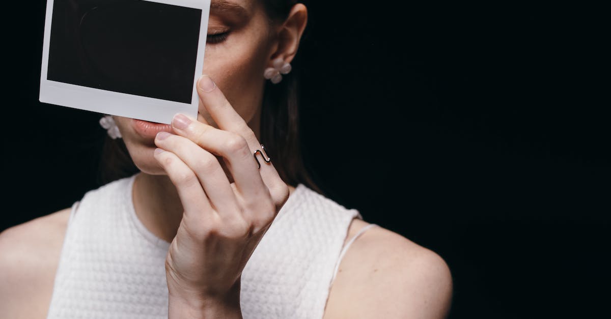 Does it make more sense to stay in Lido or Venice? [closed] - Woman in White Tank Top Holding an Instant Film