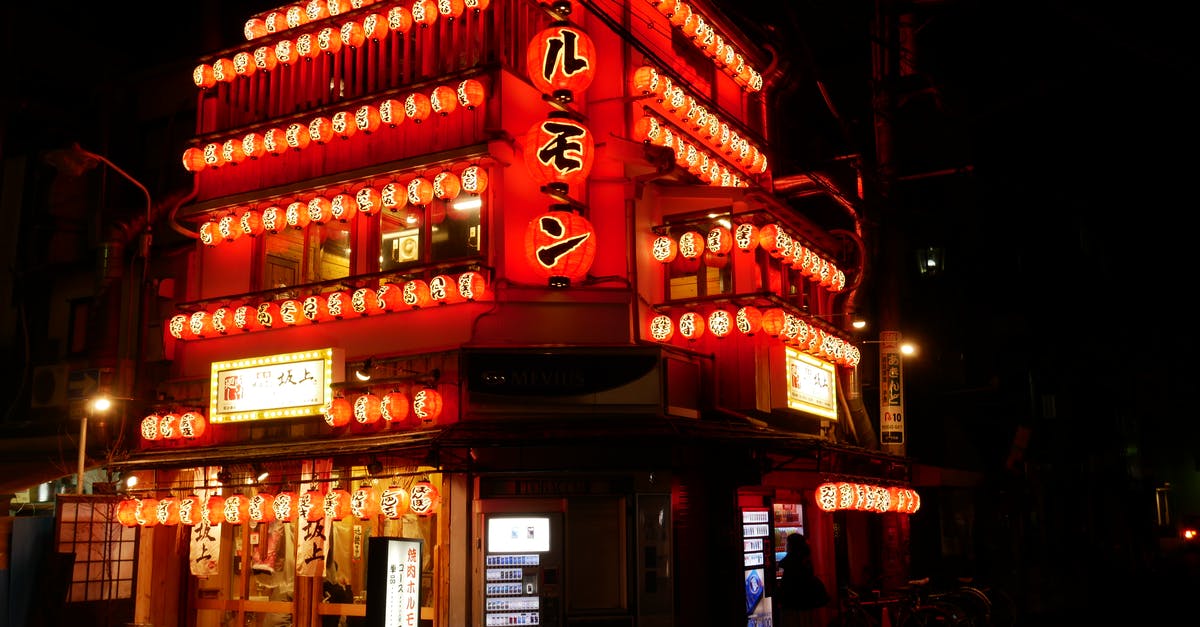 Does Japan have pubs or bars? - Red and White Concrete Building during Nighttime Does Japan have pubs or bars? - Red and White Concrete Building during Nighttime