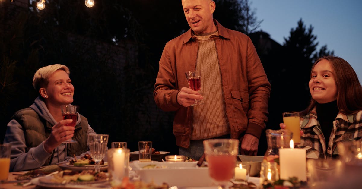 Does Madrid's metro offer children's fares? - Adult man with wineglass offering toast while standing at table with family and friends in backyard in twilight Does Madrid's metro offer children's fares? - Adult man with wineglass offering toast while standing at table with family and friends in backyard in twilight