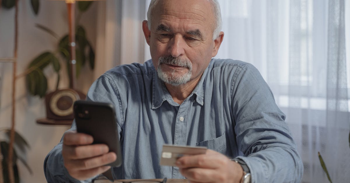 Does MasterCard work in Italy? - An Elderly Man Holding His Mobile Phone and a Credit Card Does MasterCard work in Italy? - An Elderly Man Holding His Mobile Phone and a Credit Card
