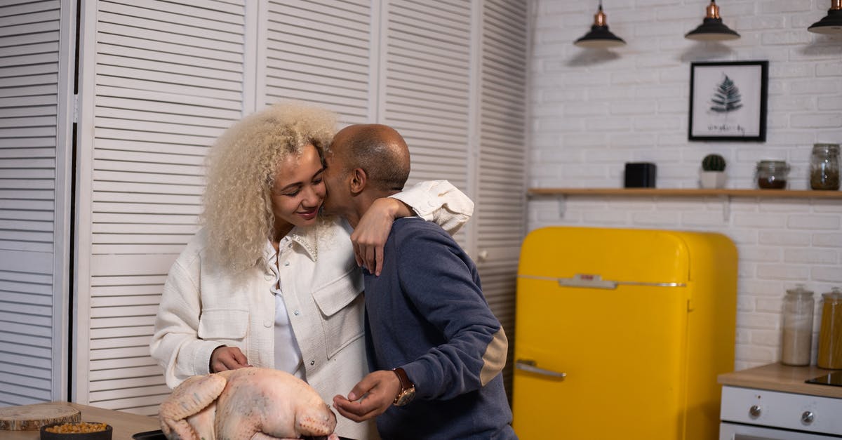 Does my husband need a visa for a layover in Turkey? [duplicate] - Tender African American husband kissing positive black wife with closed eyes while standing near counter with uncooked turkey during cooking in modern kitchen