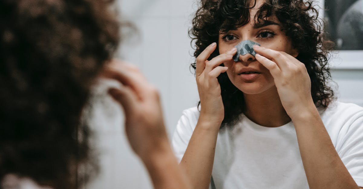 Does Nexus renewal grace period apply to enter Canada? - Calm woman applying skincare product on face Does Nexus renewal grace period apply to enter Canada? - Calm woman applying skincare product on face