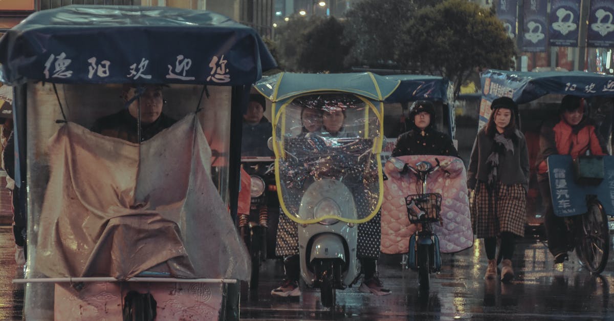 Does pollution in China suggest no bicycling? - People Riding Bicycle or Motorcycle and Walking during Rain Does pollution in China suggest no bicycling? - People Riding Bicycle or Motorcycle and Walking during Rain