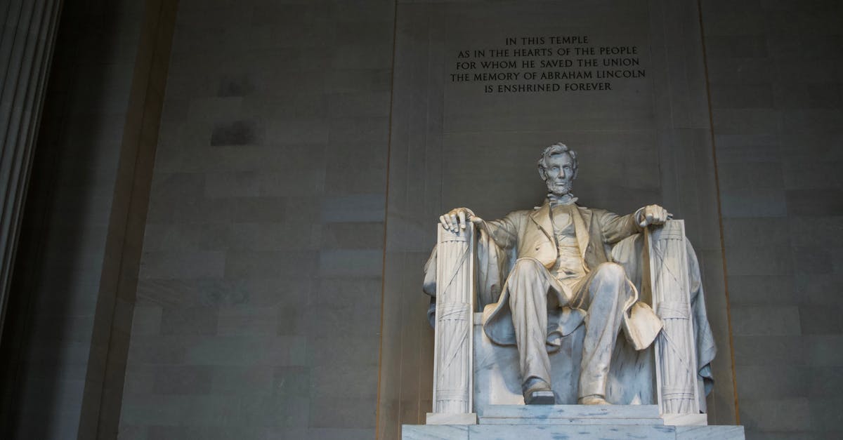 Does the 2018-2019 US government shutdown affect travelling to and from the US? - From below of marble statue of American president sitting on chair near wall with inscription located in Washington DC