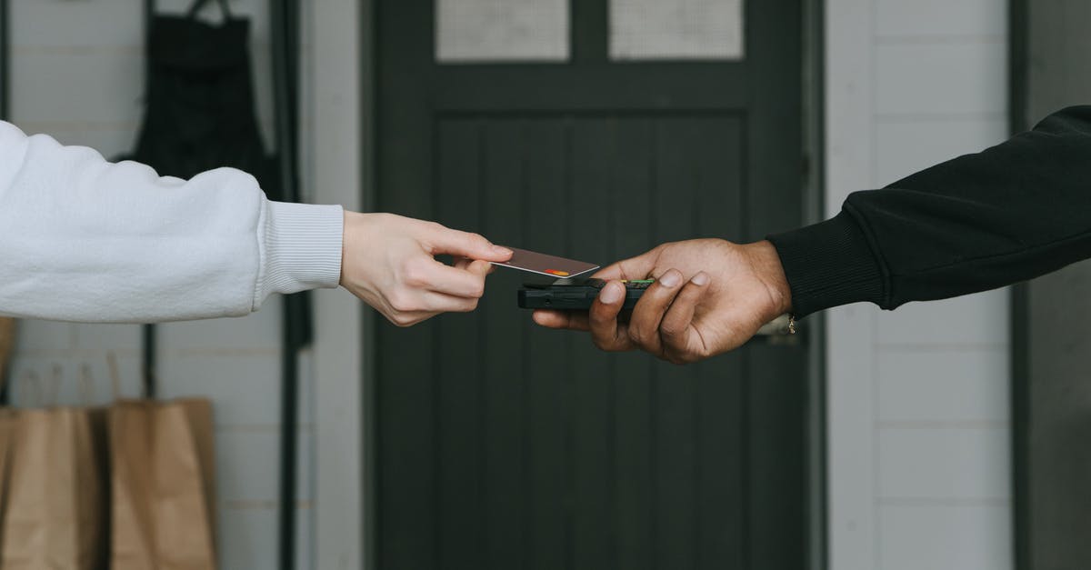 Does the booking service usually save your credit card information and share it with the hotel? - A Person Paying Cashless