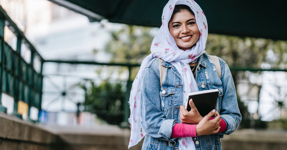 Does the JR East pass cover my route? - Content ethnic female in headscarf and denim coat with notebook looking at camera with toothy smile Does the JR East pass cover my route? - Content ethnic female in headscarf and denim coat with notebook looking at camera with toothy smile