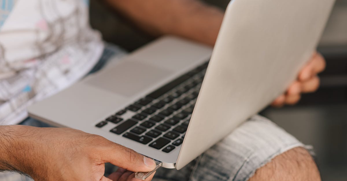 Does the Schengen Visa (short stay) application for France really require a fully prepaid accommodation? Too much inconsistent information online - Crop faceless man using laptop and inserting flashcard