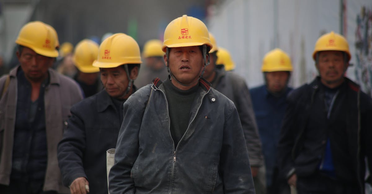 Does the UK have any constraint on work permit for previous Chinese work permit holders? - Group of Persons Wearing Yellow Safety Helmet during Daytime Does the UK have any constraint on work permit for previous Chinese work permit holders? - Group of Persons Wearing Yellow Safety Helmet during Daytime