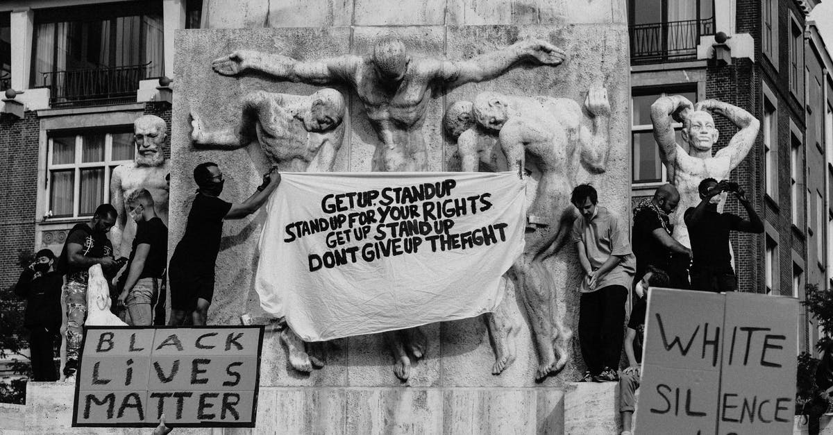 Does Timatic information grant you the right to get on a flight? - Black and white of crowd of people standing on city street with carton boards during social protest Does Timatic information grant you the right to get on a flight? - Black and white of crowd of people standing on city street with carton boards during social protest