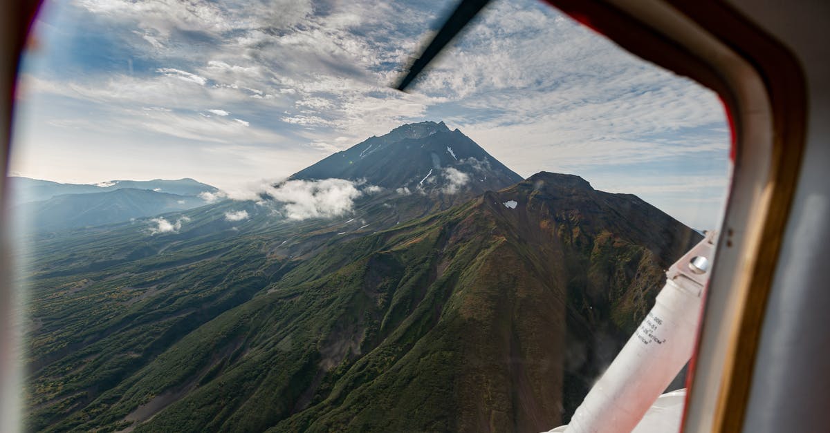 Does travel insurance for short flight delays exist? - Green and Brown Mountains Under White Clouds Does travel insurance for short flight delays exist? - Green and Brown Mountains Under White Clouds