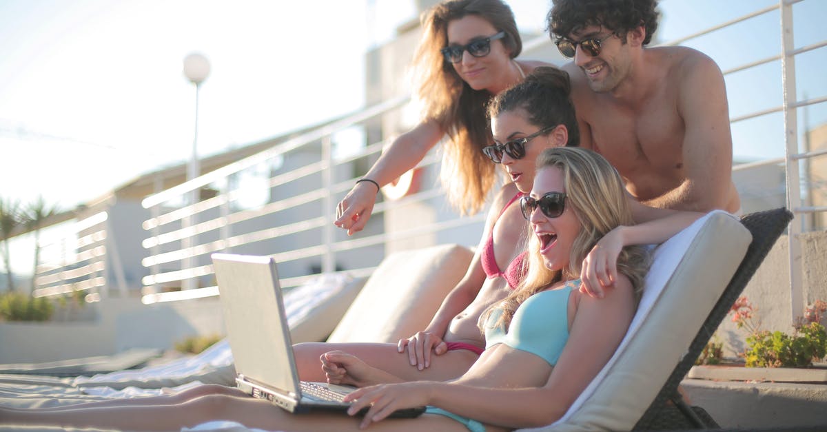 Does using International SOS amount to having travel insurance? - Happy young friends in swimsuits and sunglasses watching video on netbook while lounging on deckchairs near pool on summer weekend Does using International SOS amount to having travel insurance? - Happy young friends in swimsuits and sunglasses watching video on netbook while lounging on deckchairs near pool on summer weekend