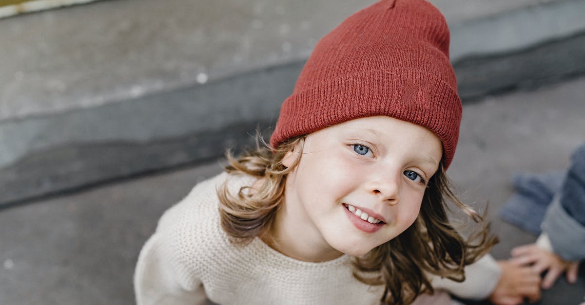 Does USMLE Step 2 CS Annotation on B-1/B-2 visa restrict me from doing electives? - From above of cheerful girl in hat looking at camera while sitting on doorstep with anonymous kid on blurred background