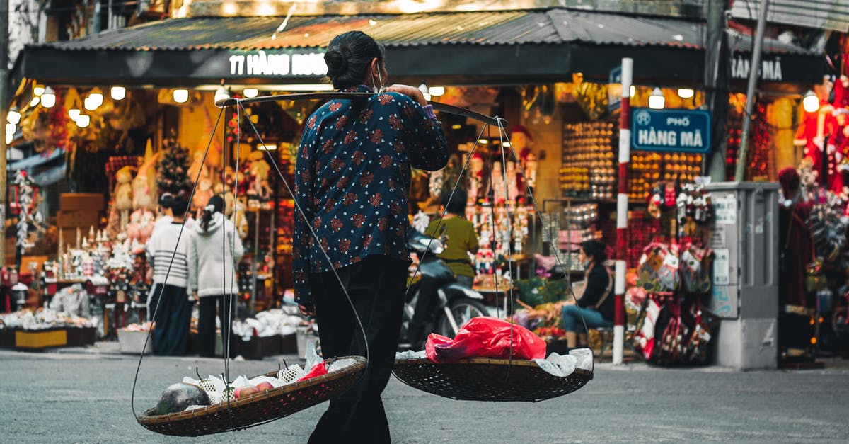 Does Vietnam allow concurrent passports? - A Woman Carrying Winnowing Baskets with Fresh Fruits Does Vietnam allow concurrent passports? - A Woman Carrying Winnowing Baskets with Fresh Fruits