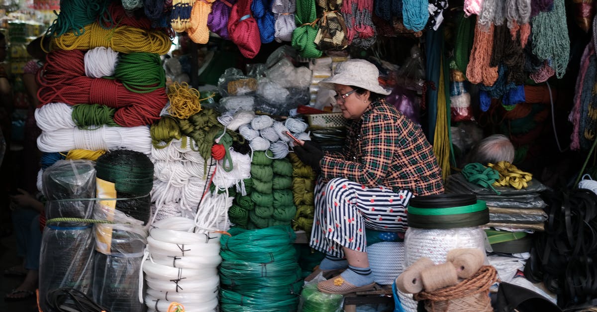 Does Vietnam store visas digitally? - Woman in Black and White Striped Long Sleeve Shirt Sitting In Front Of Her Store Does Vietnam store visas digitally? - Woman in Black and White Striped Long Sleeve Shirt Sitting In Front Of Her Store