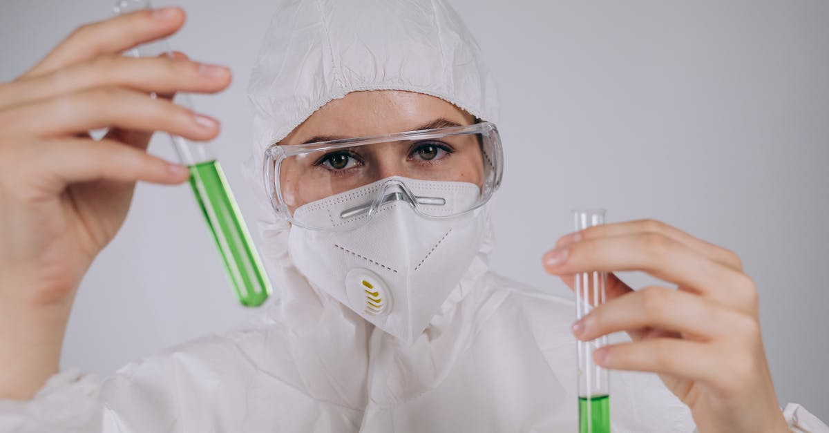 Doing research on ESTA / J-1 visa - A Person Wearing Personal Protective Equipment Holding Test Tubes Doing research on ESTA / J-1 visa - A Person Wearing Personal Protective Equipment Holding Test Tubes